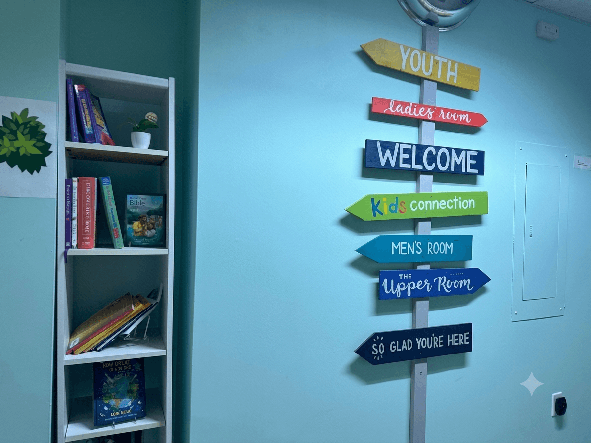 Colorful directional signs pointing to Kids Connection and Youth