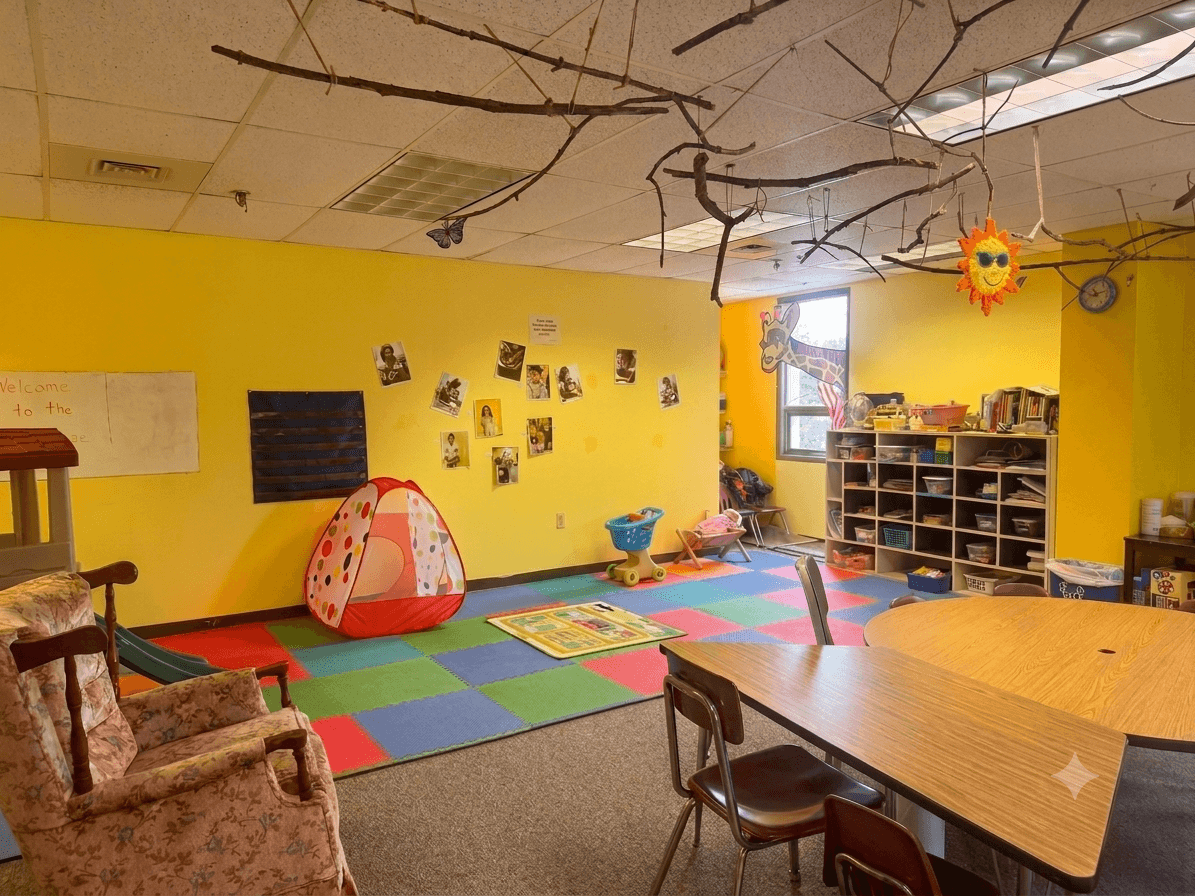 Yellow preschool classroom with play tent and reading corner