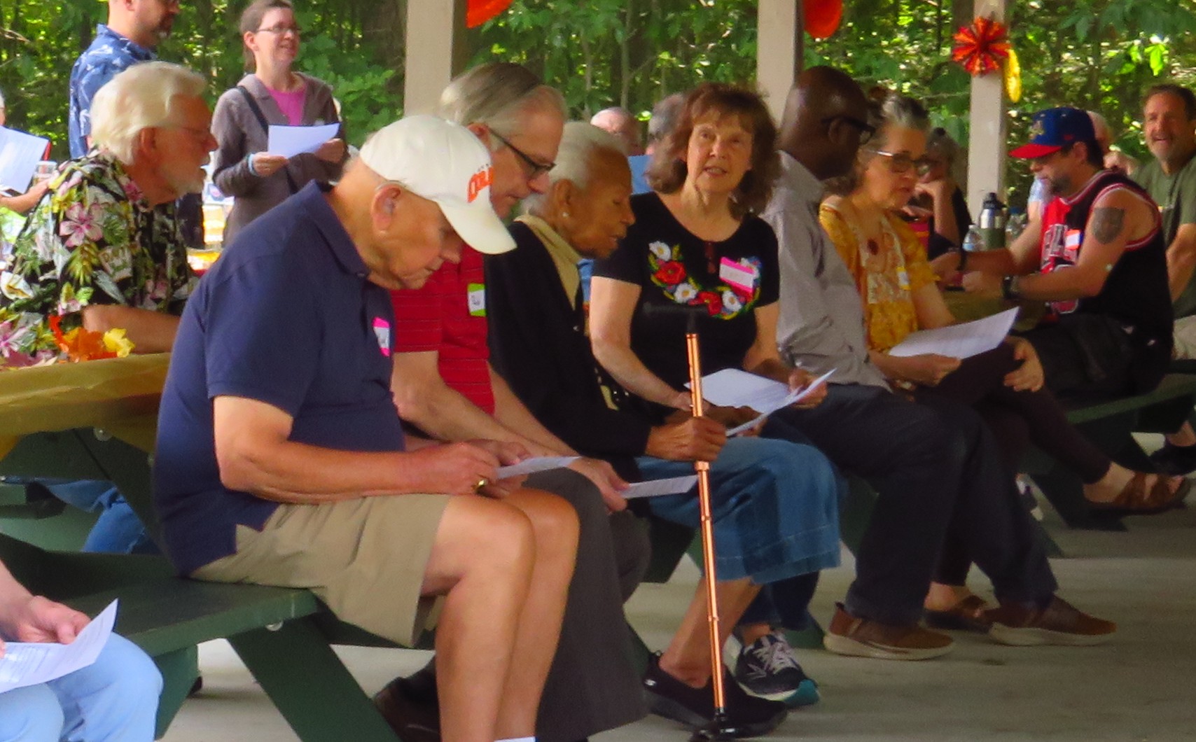 Church family singing together from printed song sheets